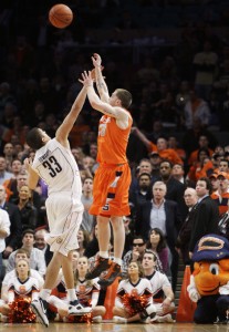 BEast Syracuse Connecticut Basketball Syracuse's Eric Devendorf, right, puts up a three-point shot over Connecticut's Gavin Edwards at the end of regulation during a quarterfinal NCAA college basketball game at the Big East men's tournament Thursday, March 12, 2009 at Madison Square Garden in New York. The shot, which would have won the game fell through the net, but referees reviewed the play and determined that time had run out before the release forcing the game into overtime. After six overtime periods Syracuse won 127-117. (AP Photo/Julie Jacobson)
